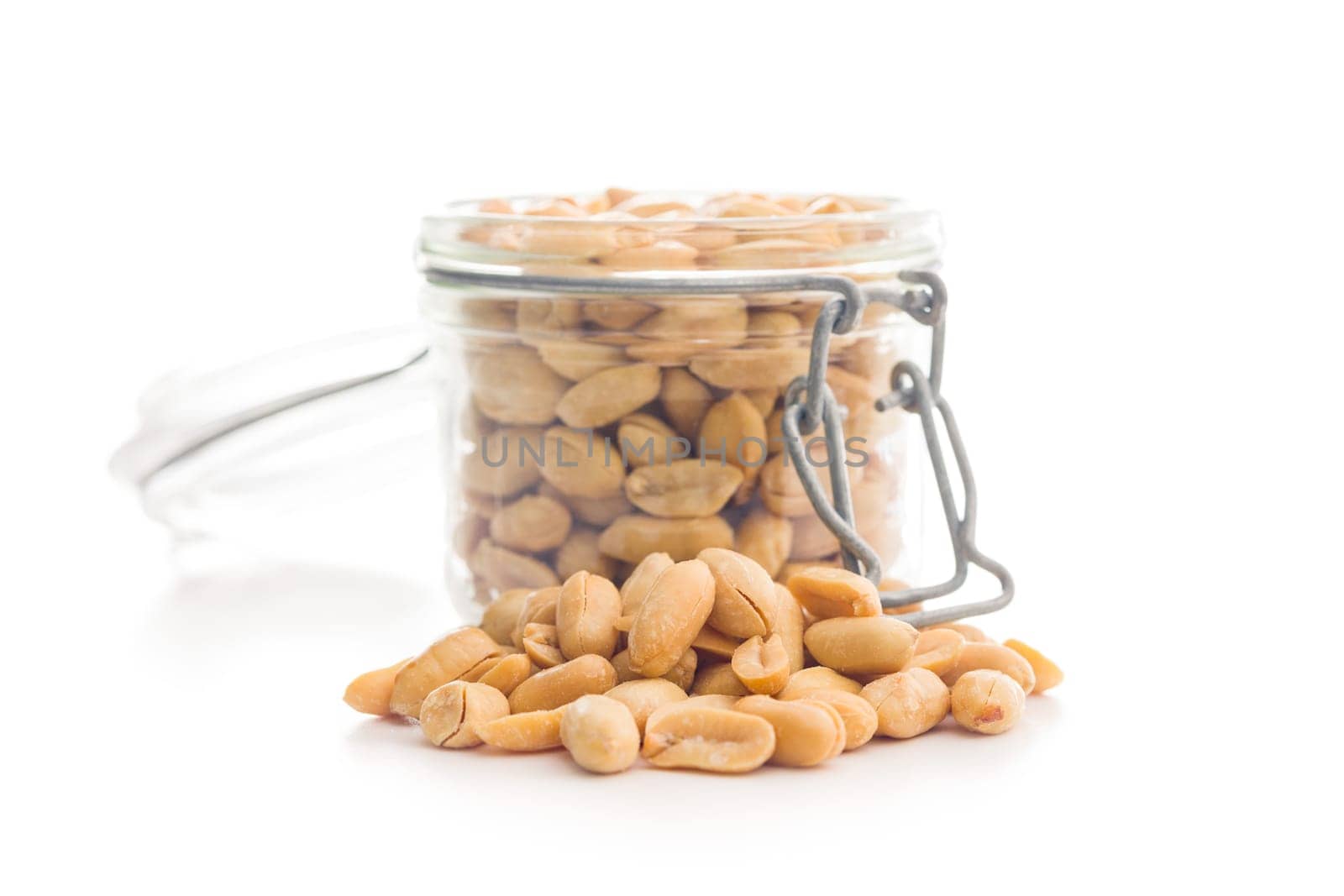Roasted salted peanuts in jar isolated on a white background.