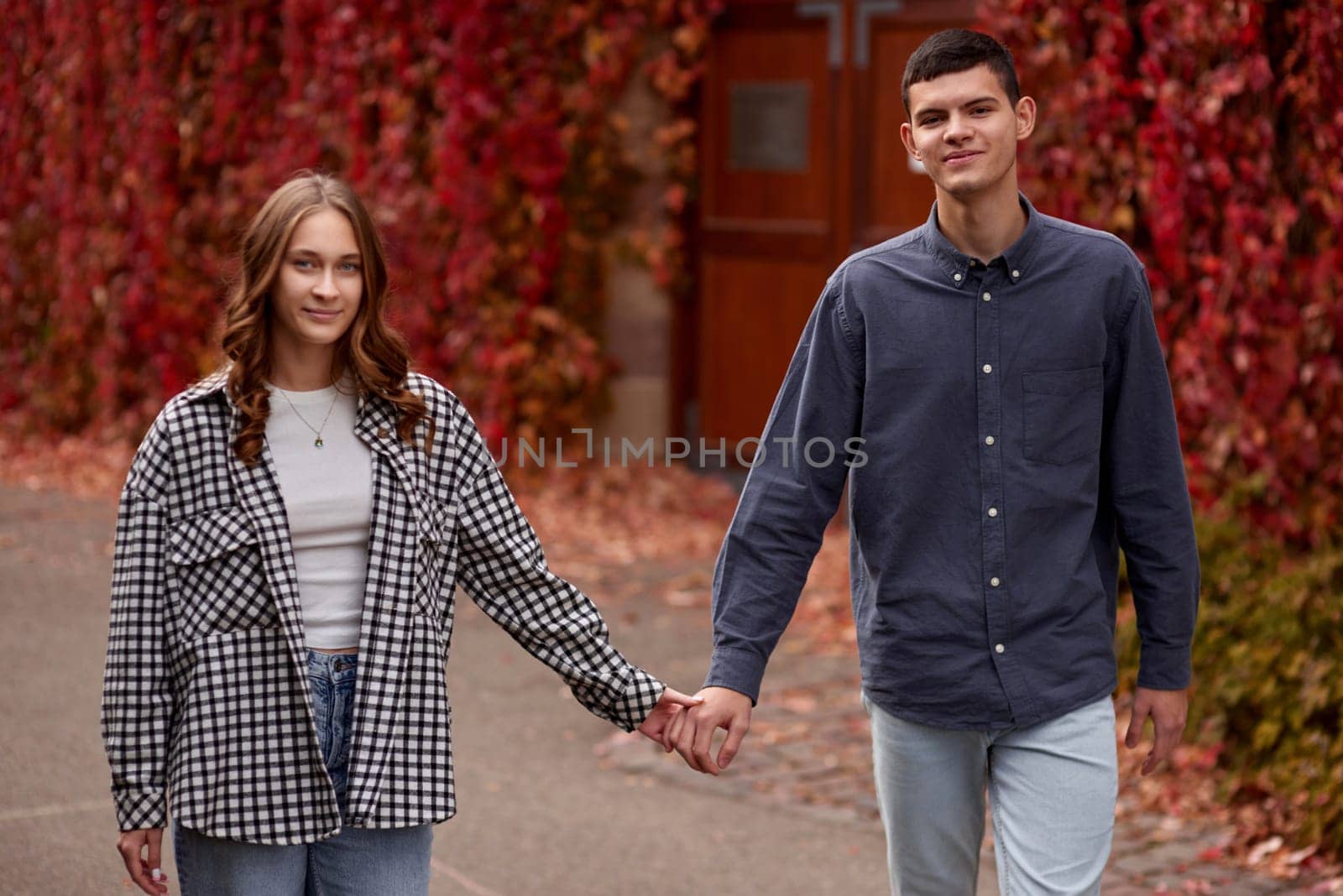 Young Cute Female Hugs Boyfriend. In Autumn Outdoor. Lovers Walking in Park. Attractive Funny Couple. Lovestory in Forest. Man and Woman. Cute Lovers in the Park. Family Concept. Happy Couple.