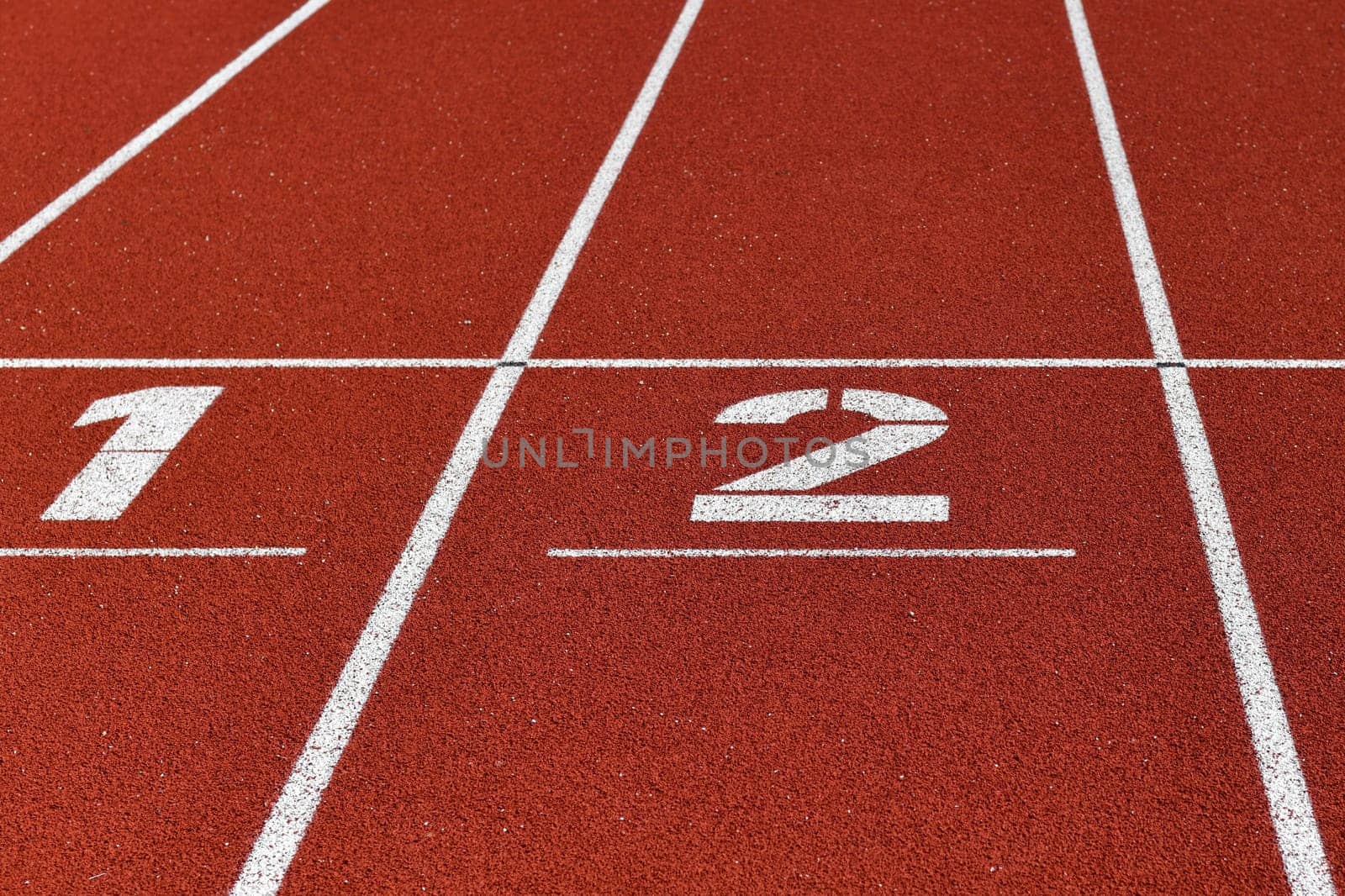 The red runway is numbered in a stadium