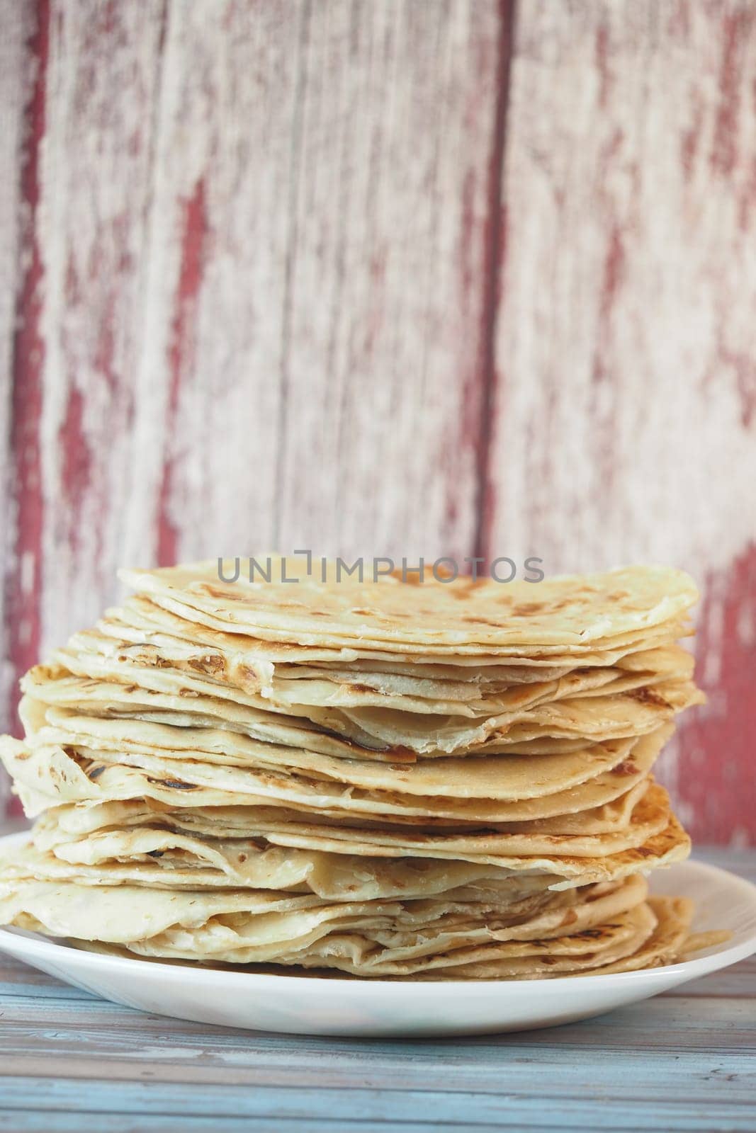stack of chapati on a plate .
