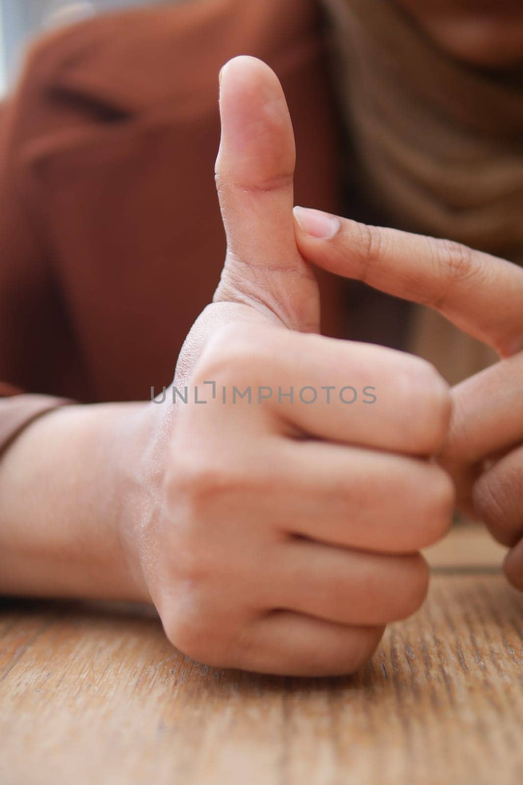 young woman suffering pain on her finger .