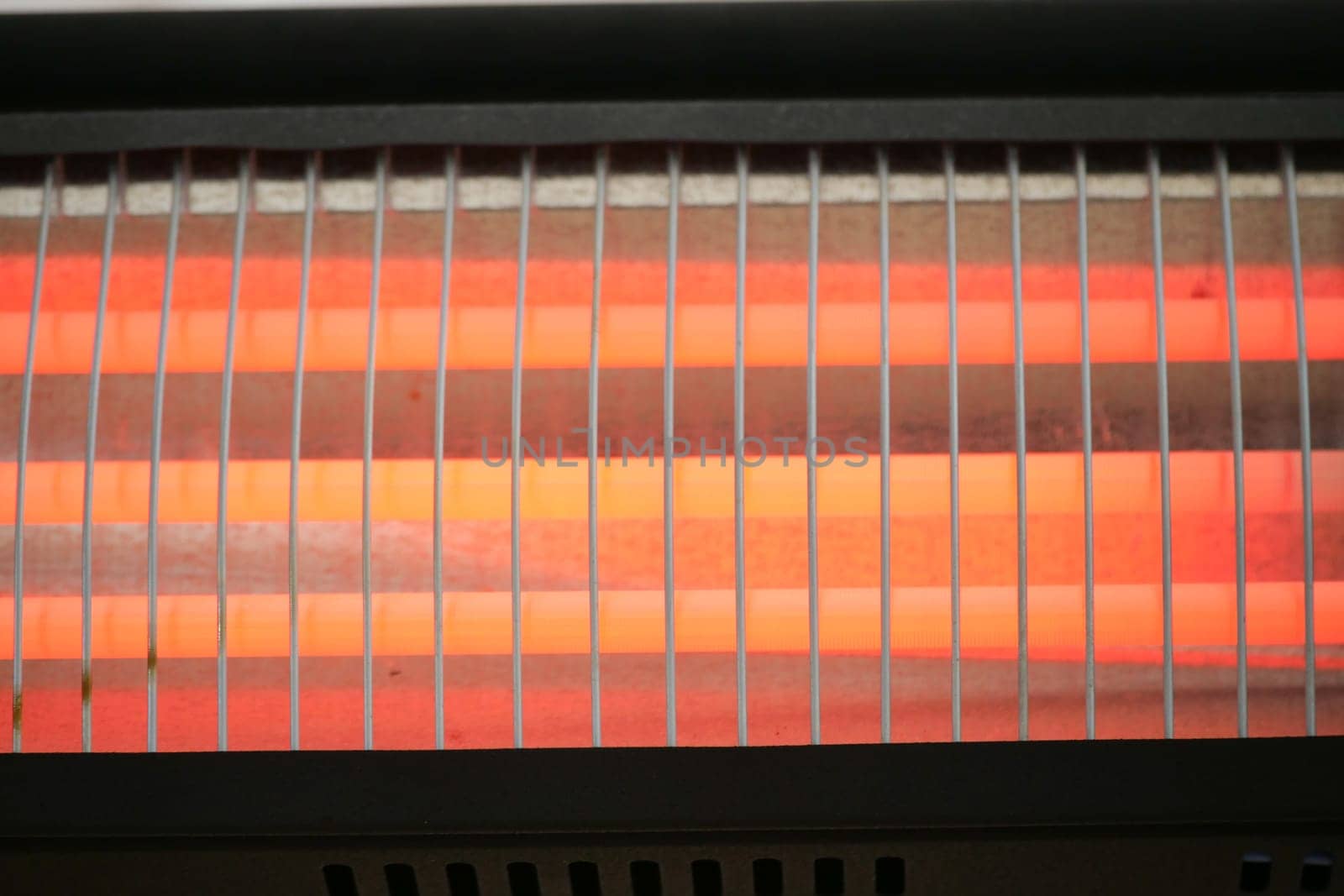 Radiant electric heater provides warmth during cold winter nights indoors.
