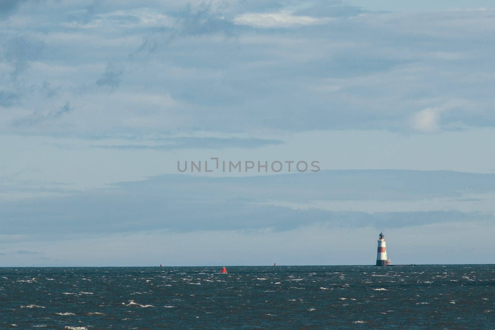 Lighthouse on the sea at sunny day - horizontal shot