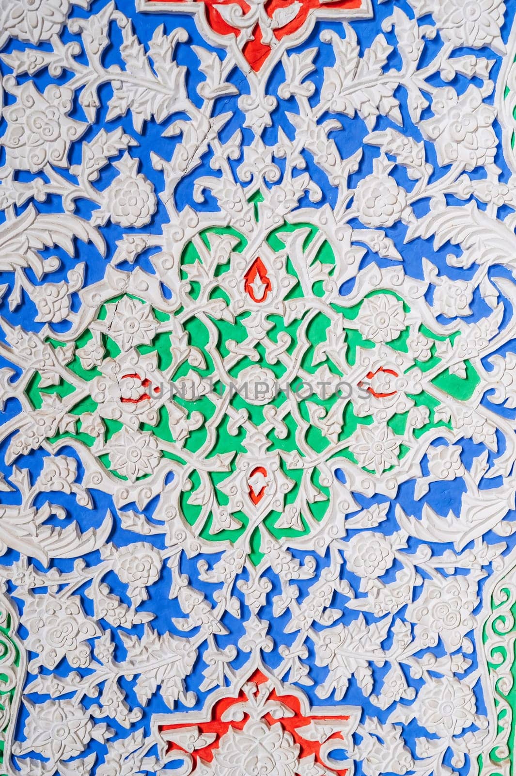 colorful carved wooden painted background with traditional Uzbek ornaments and oriental patterns in Tashkent in Uzbekistan