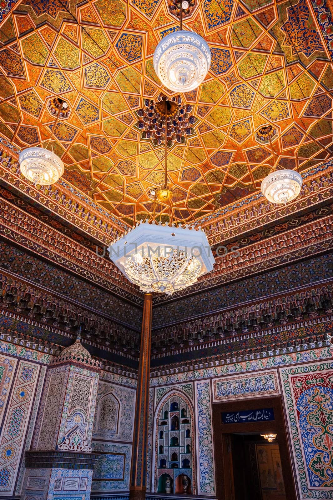 beautiful interior with painted wooden carved ceiling and walls in Museum of Art of Uzbekistan with Uzbek patterns and oriental ornaments in palace in Tashkent