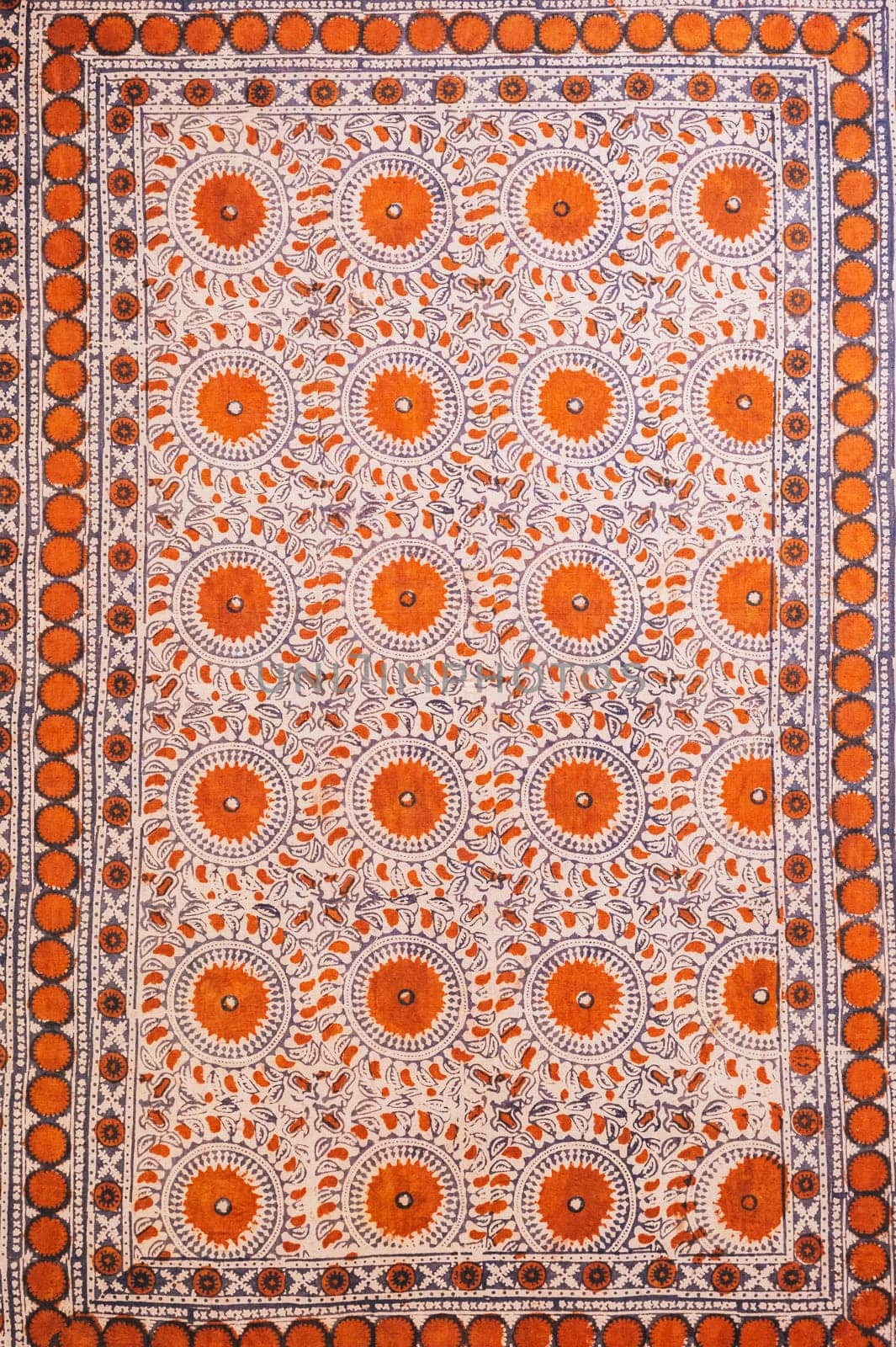 traditional Uzbek geometric pattern on an ancient vintage carpet in Uzbekistan. Oriental background with beautiful ornaments