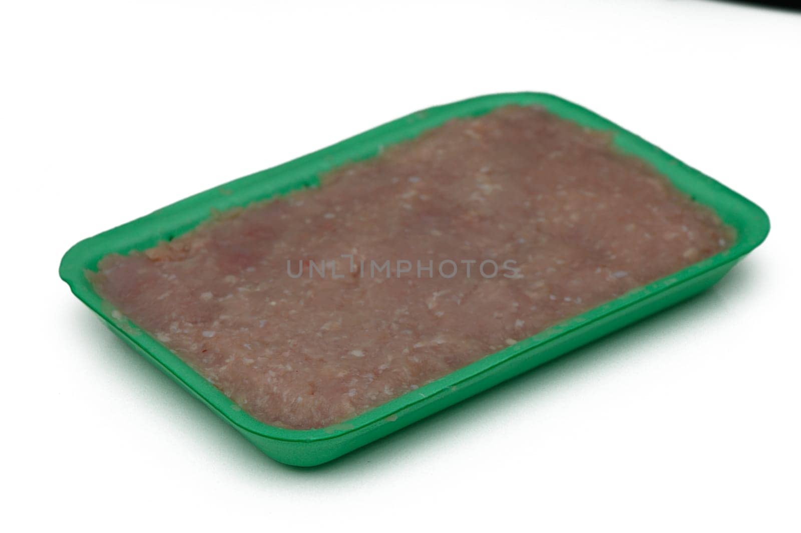 Freshly packaged ground meat sits in a bright green tray, ready to be transformed into savory dishes. Perfect for grilling or sauteing for any culinary creation.
