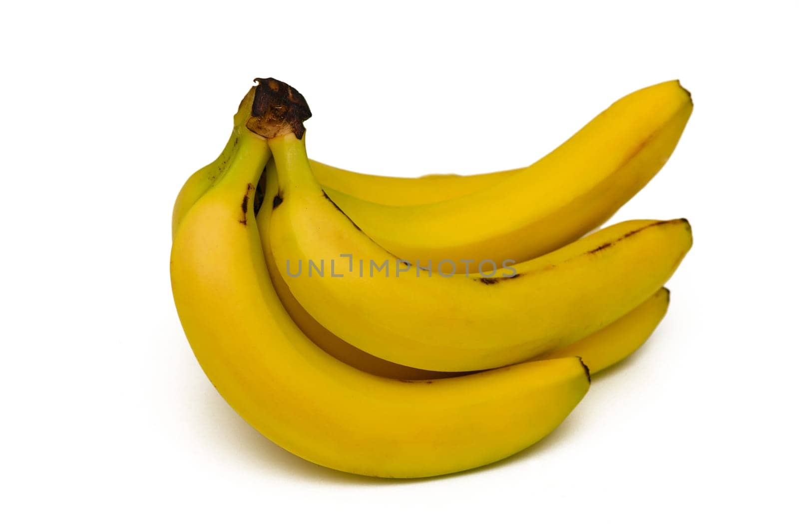 A cluster of bright yellow bananas showcases their ripeness, glistening under soft light, inviting anyone nearby to savor their sweetness and nutrition.