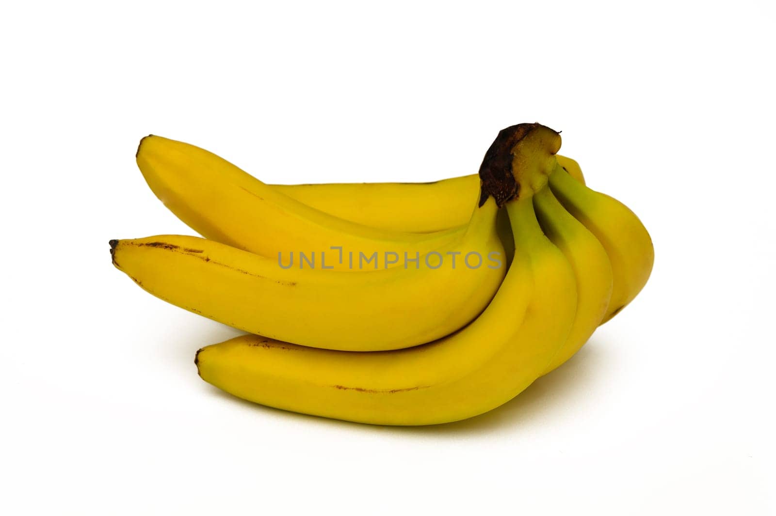 Four ripe bananas are arranged neatly, their smooth yellow skins glistening under soft light. This still life composition highlights the freshness and appeal of the fruit against a plain background.