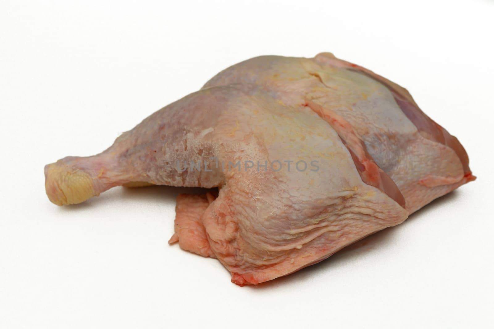 Brightly lit kitchen countertop displays a raw chicken cut, highlighting its tender surface and organic appearance, ready for seasoning and cooking as part of a delicious meal.