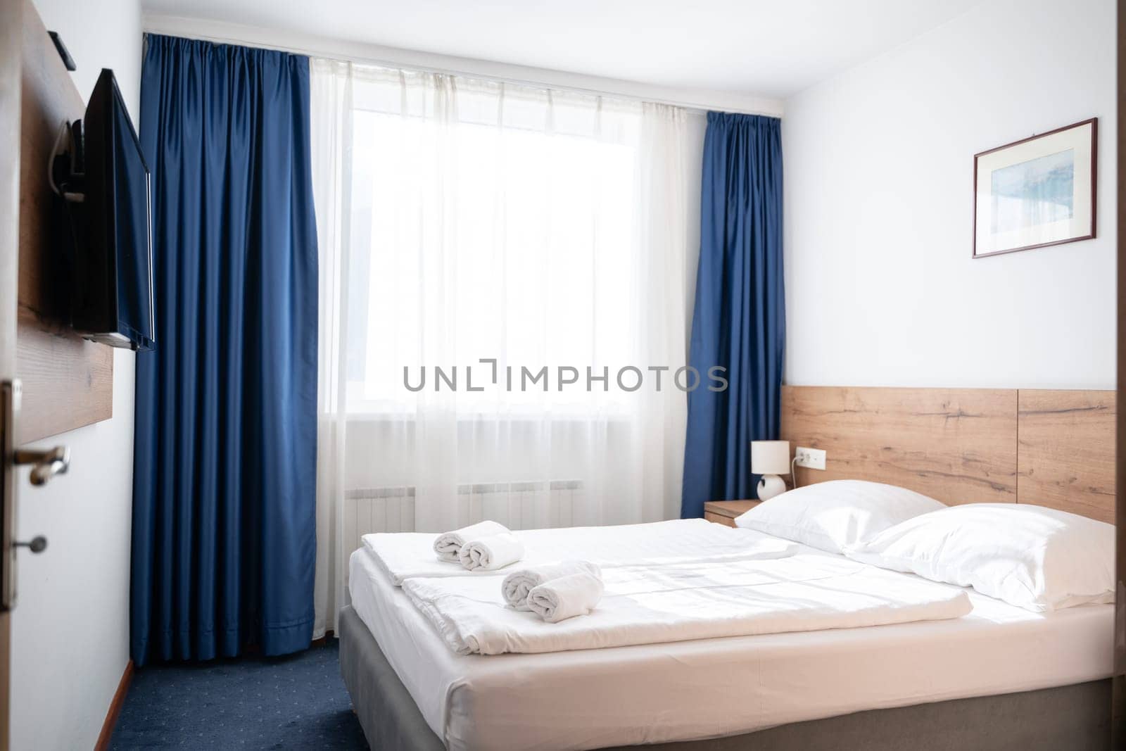 A modern and serene hotel room in a medical rehabilitation facility, designed for comfort and relaxation, offering a peaceful environment for patients to recover and rejuvenate.