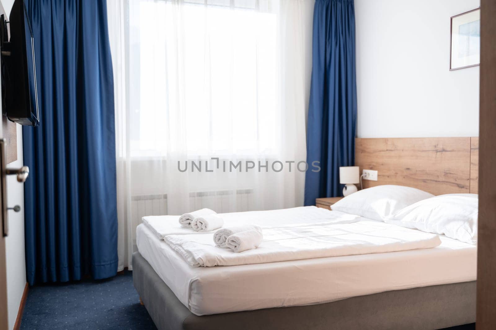 A modern and serene hotel room in a medical rehabilitation facility, designed for comfort and relaxation, offering a peaceful environment for patients to recover and rejuvenate.