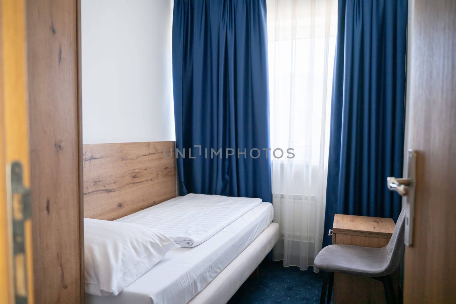 A modern and serene hotel room in a medical rehabilitation facility, designed for comfort and relaxation, offering a peaceful environment for patients to recover and rejuvenate.