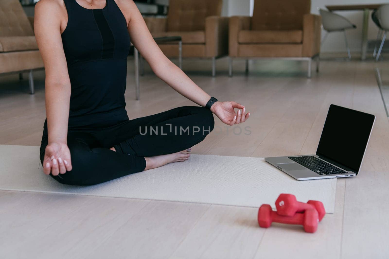 Young Beautiful Female Exercising, Stretching and Practising Yoga with Trainer via Video Call Conference in Bright Sunny House. Healthy Lifestyle, Wellbeing and Mindfulness Concept