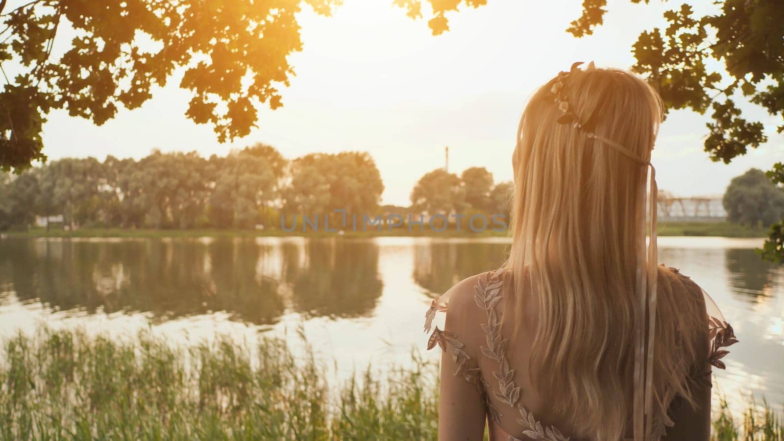 Beautiful young blond woman outdoors portrait near the lake