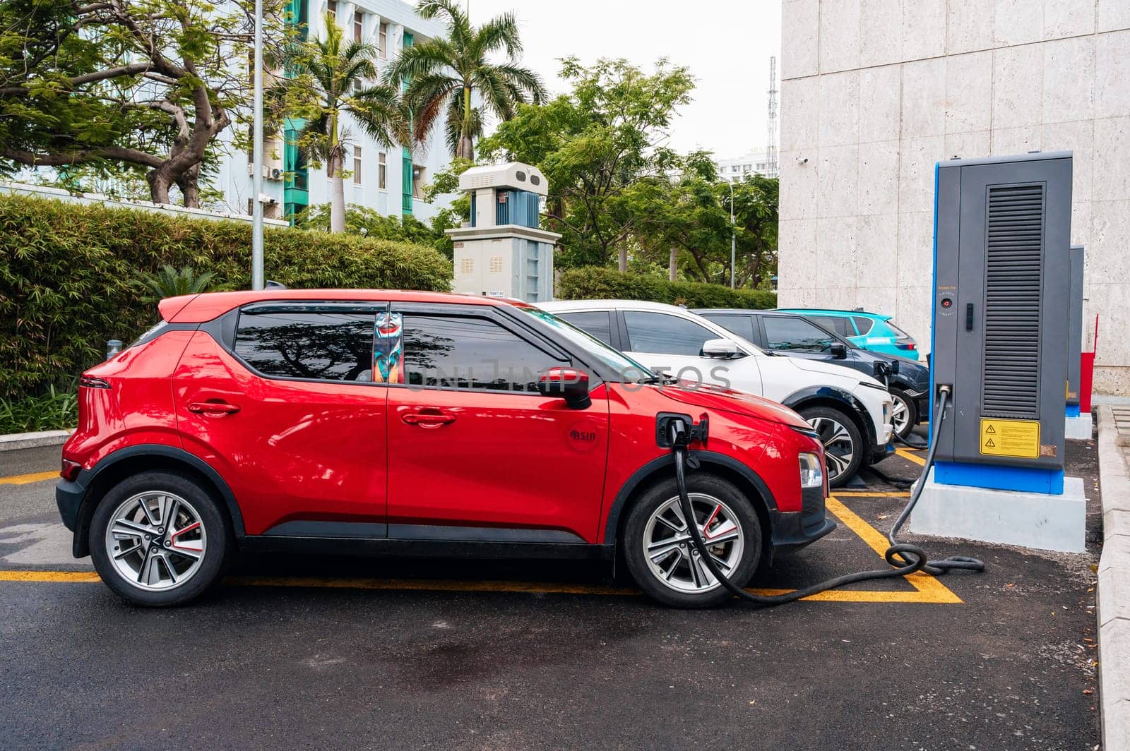 Modern Vietnamese Vinfast electric cars at a charging station on the street in Vietnam. Nha Trang, Vietnam - April 01, 2025
