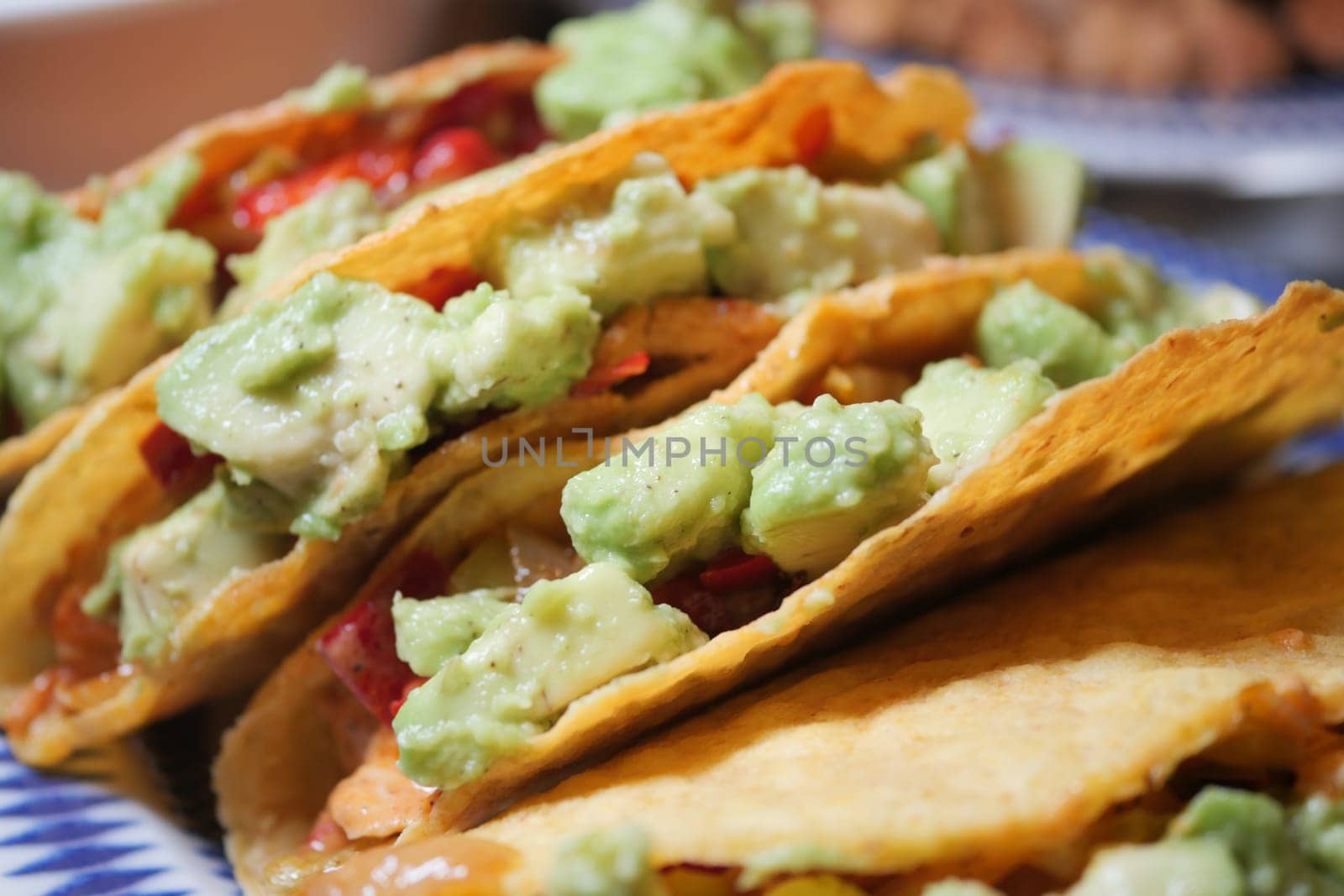 Colorful tacos with guacamole and fresh toppings are ready to enjoy.