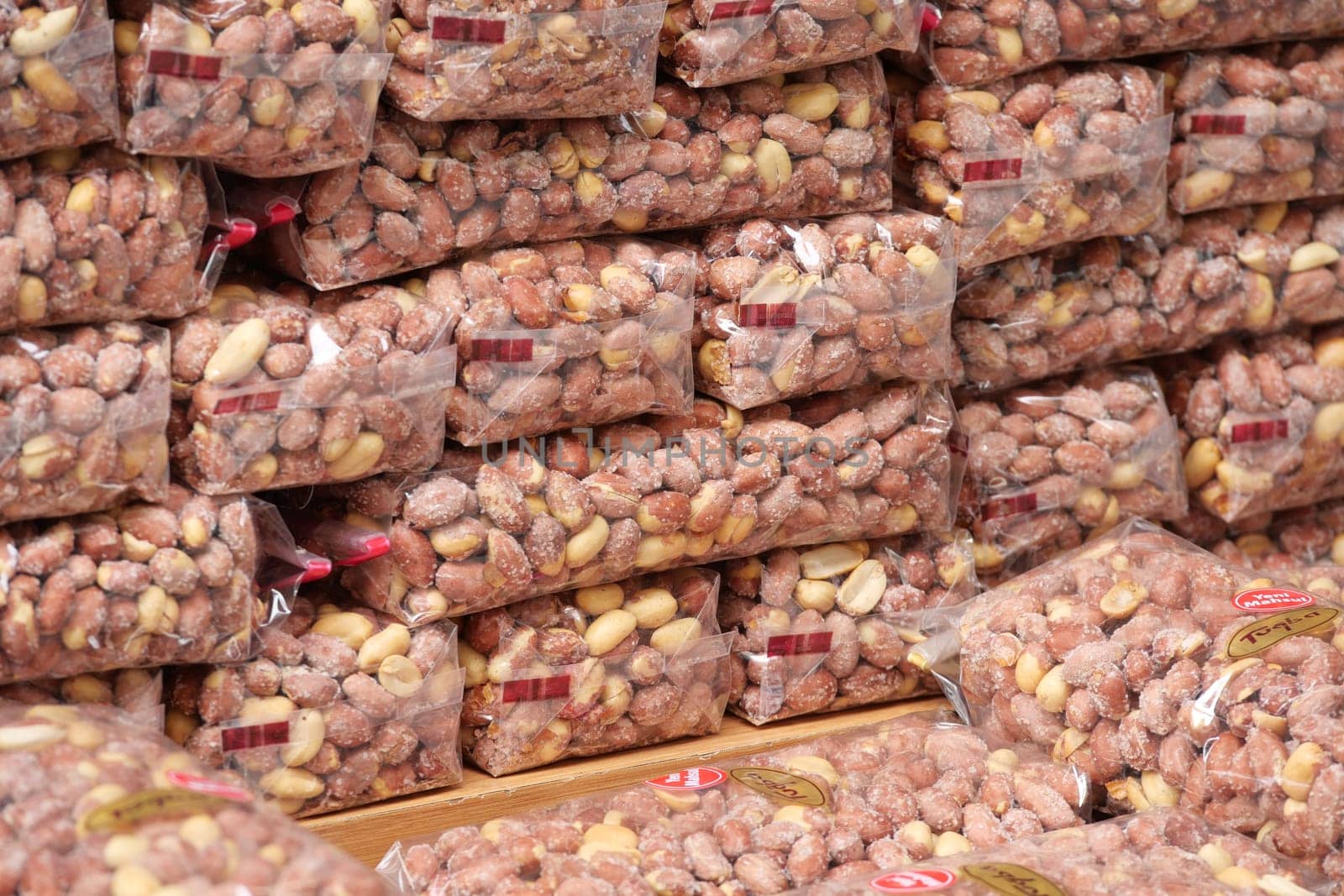 Various bags of nuts neatly stacked in a local market aisle