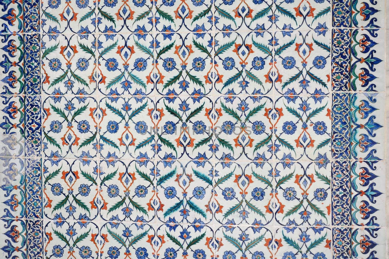 Intricate tilework features vibrant floral motifs and geometric shapes.