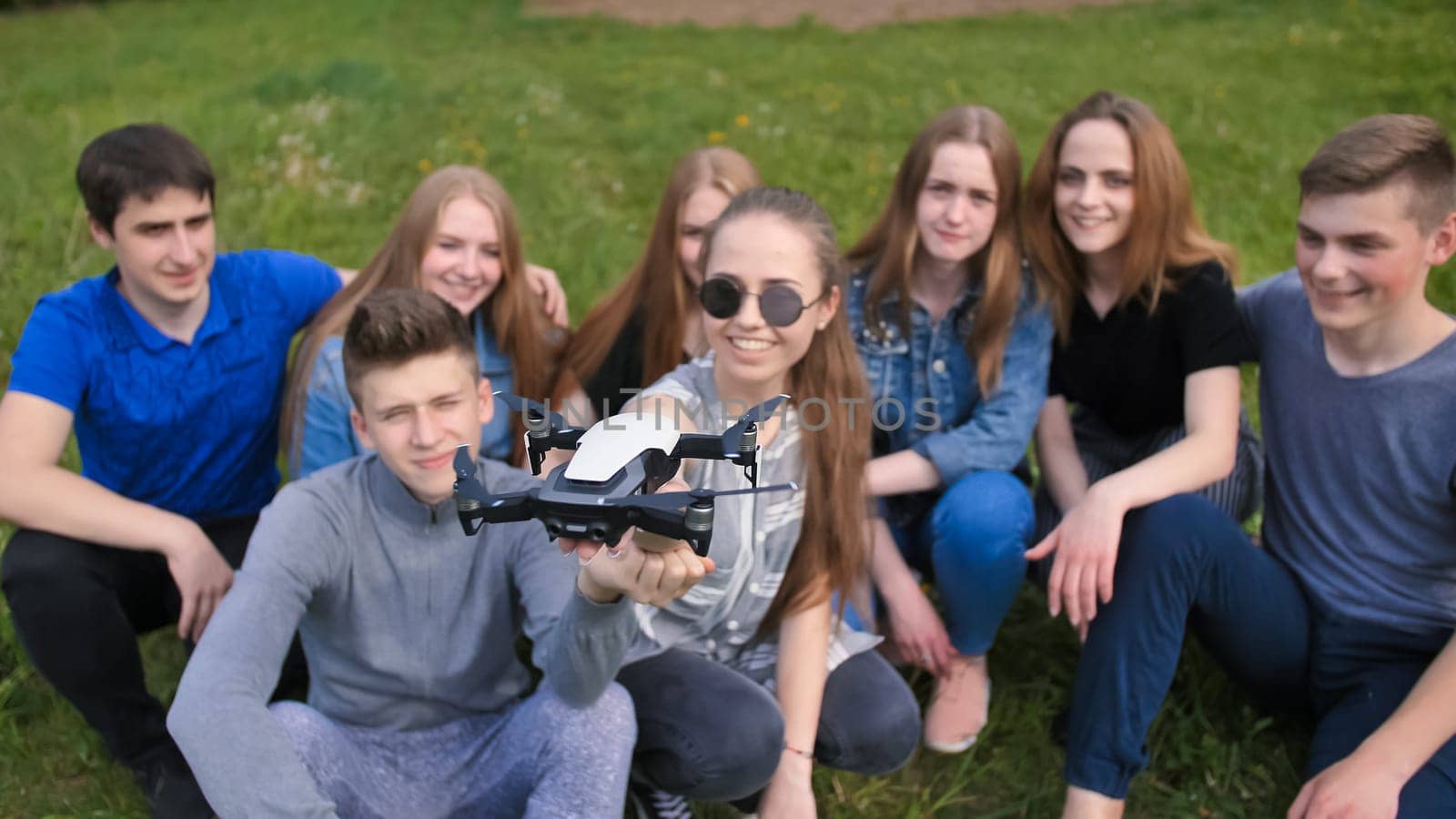 Happy cheerfulfriends launch a drone from their hands