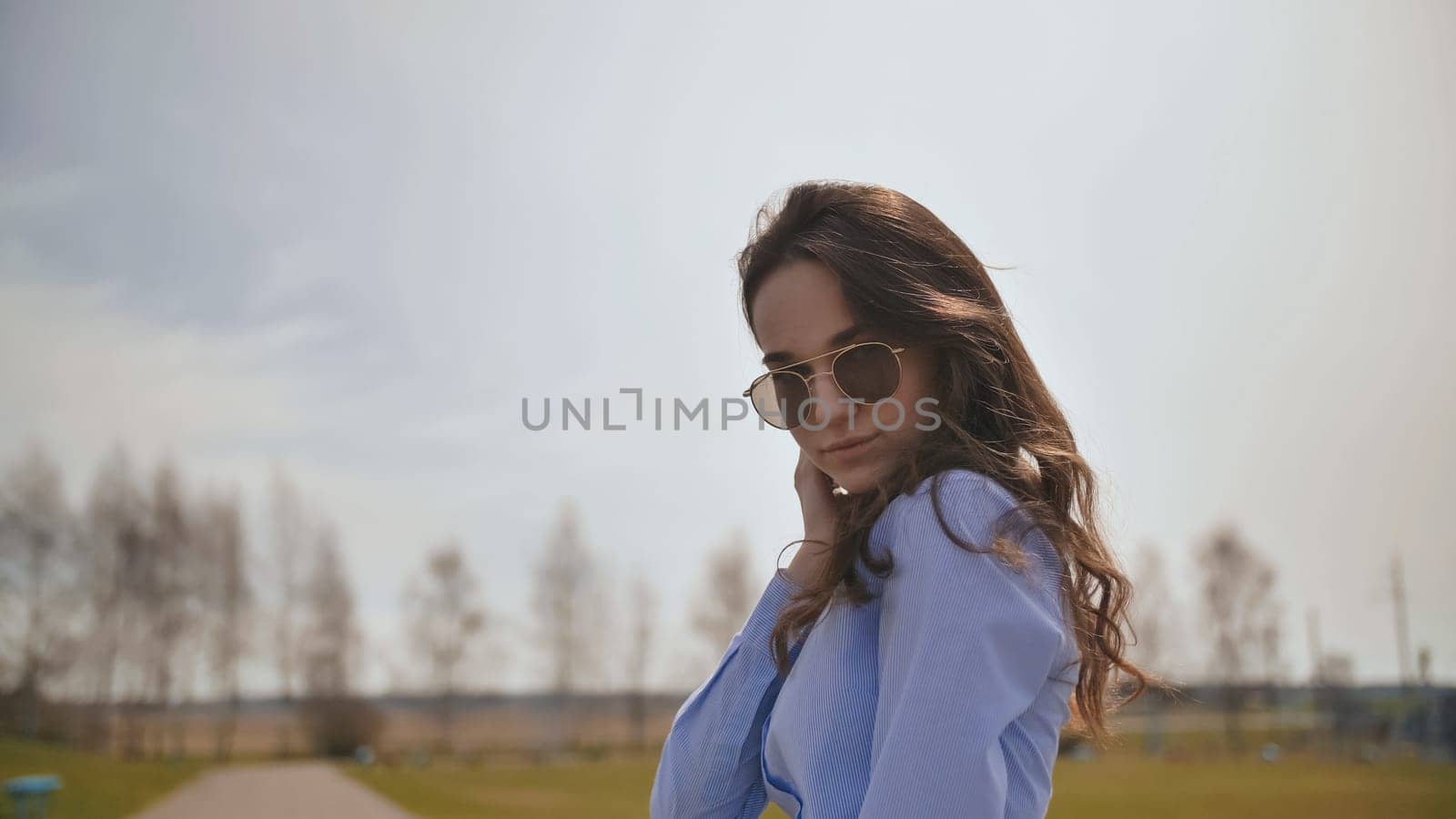 Beautiful 17 year old girl posing outdoors against the blue sky