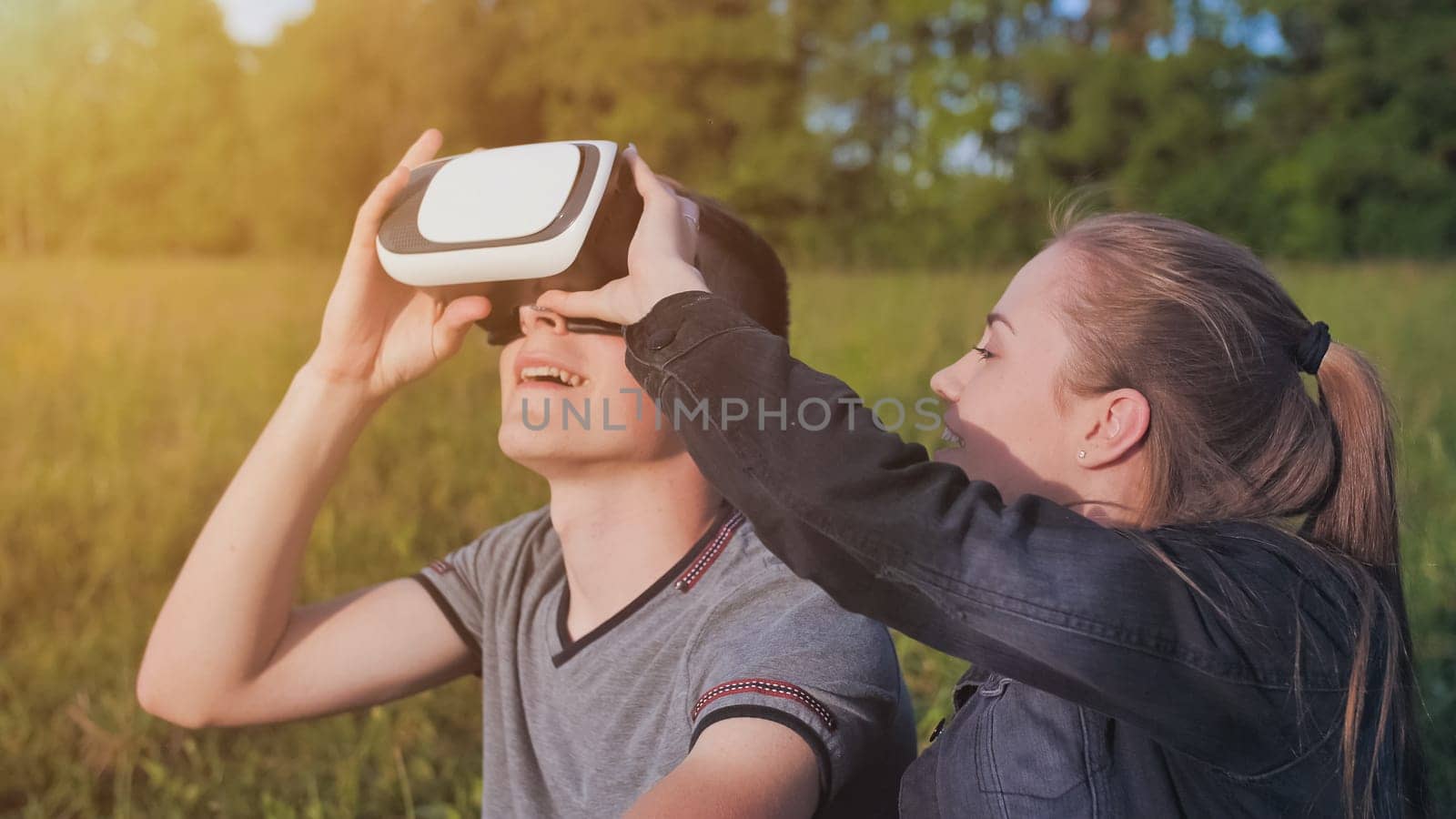 Girl and guy in virtual glasses in a city park