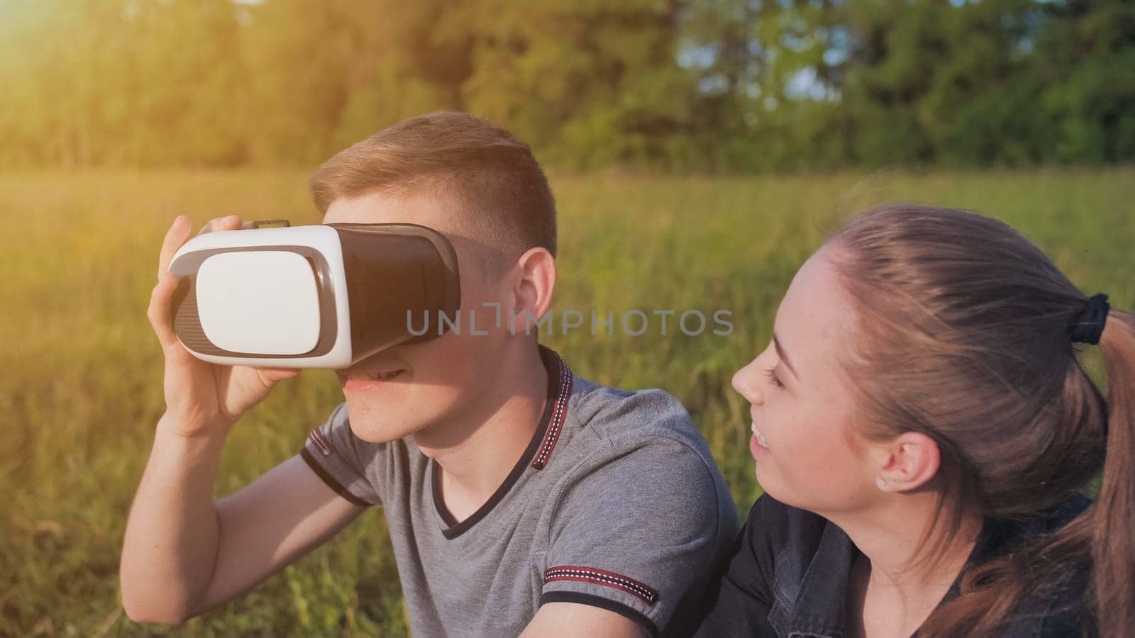 Girl and guy in virtual glasses in a city park