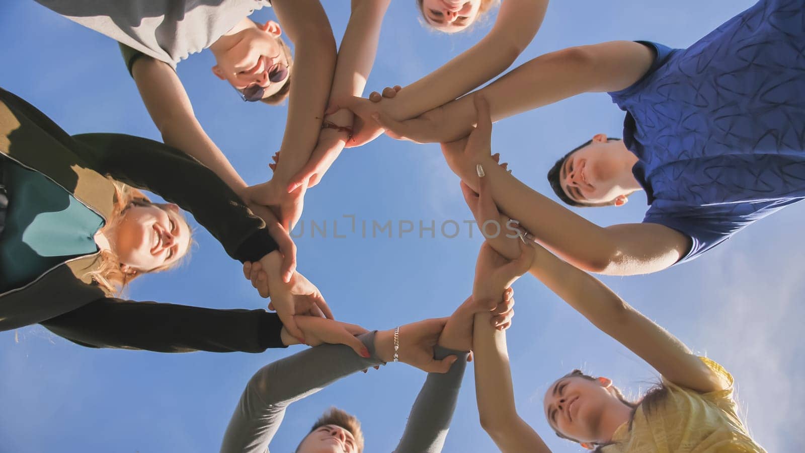 Partnership and unity concept: people holding wrists of each other.