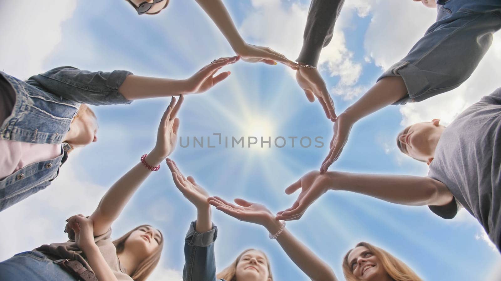 Conceptual symbol of cooperation diverse hands making a circle. Students help each other