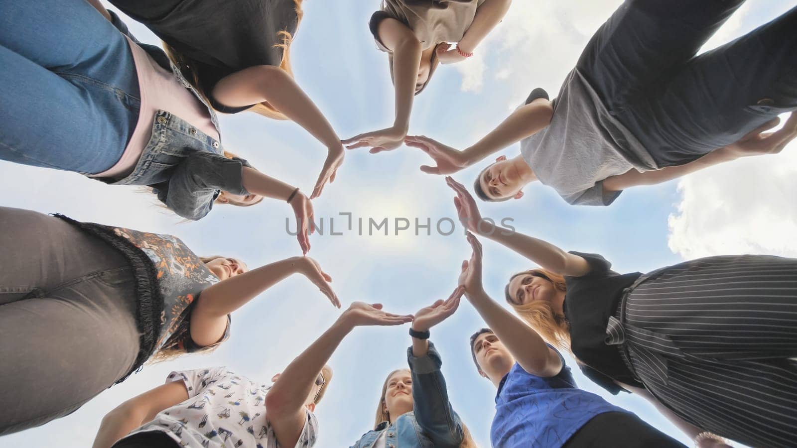 Conceptual symbol of cooperation diverse hands making a circle. Students help each other
