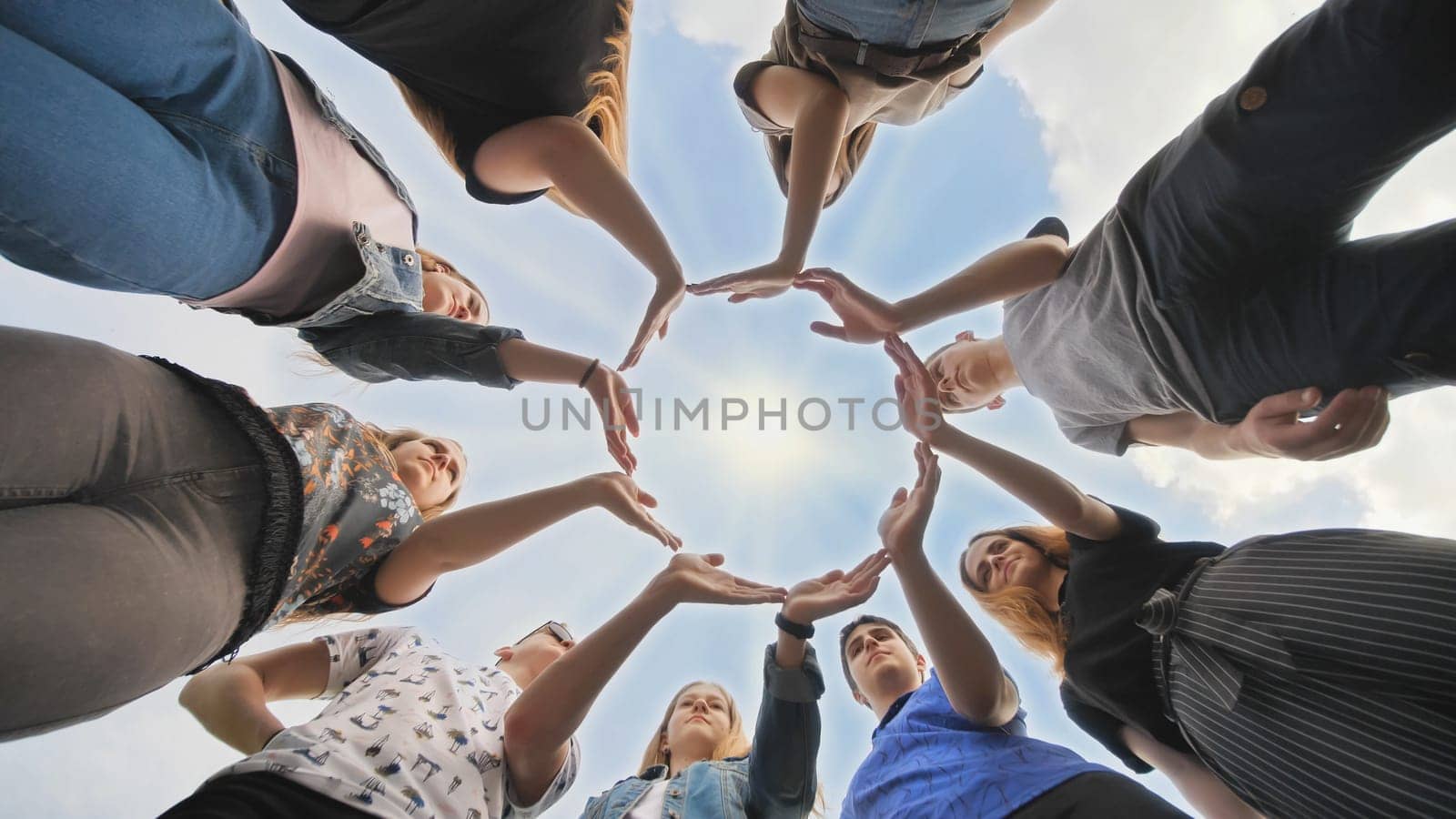 Conceptual symbol of cooperation diverse hands making a circle. Students help each other