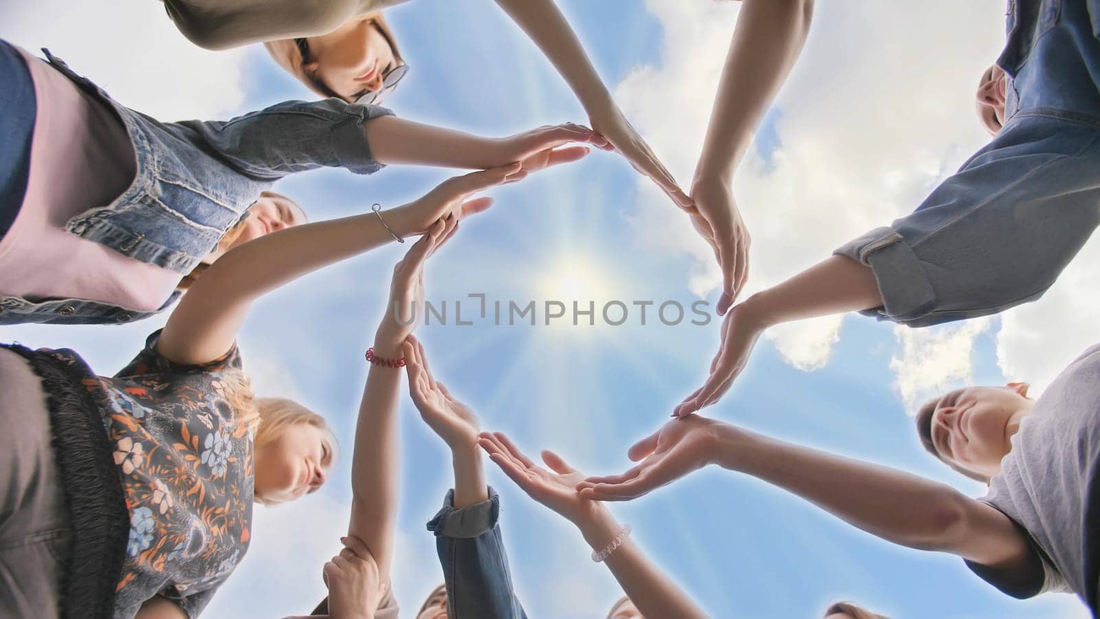 Conceptual symbol of cooperation diverse hands making a circle. Students help each other