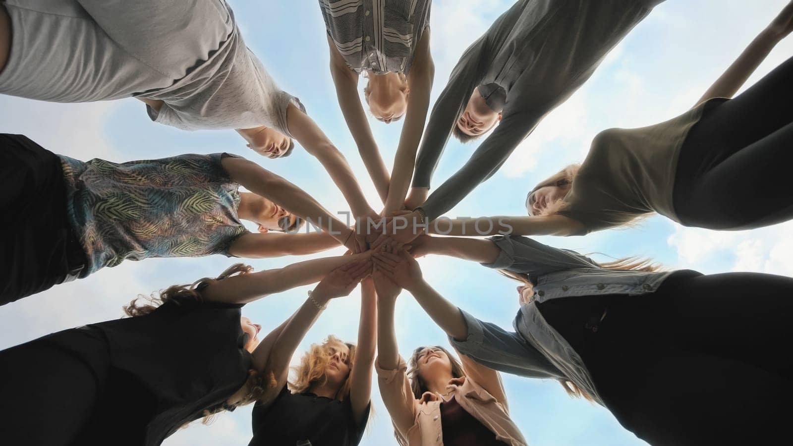Friends join their hands as a sign of their strong friendship