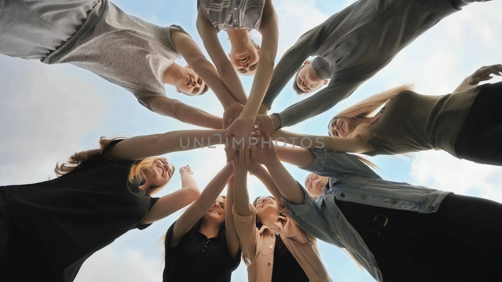 Friends join their hands as a sign of their strong friendship