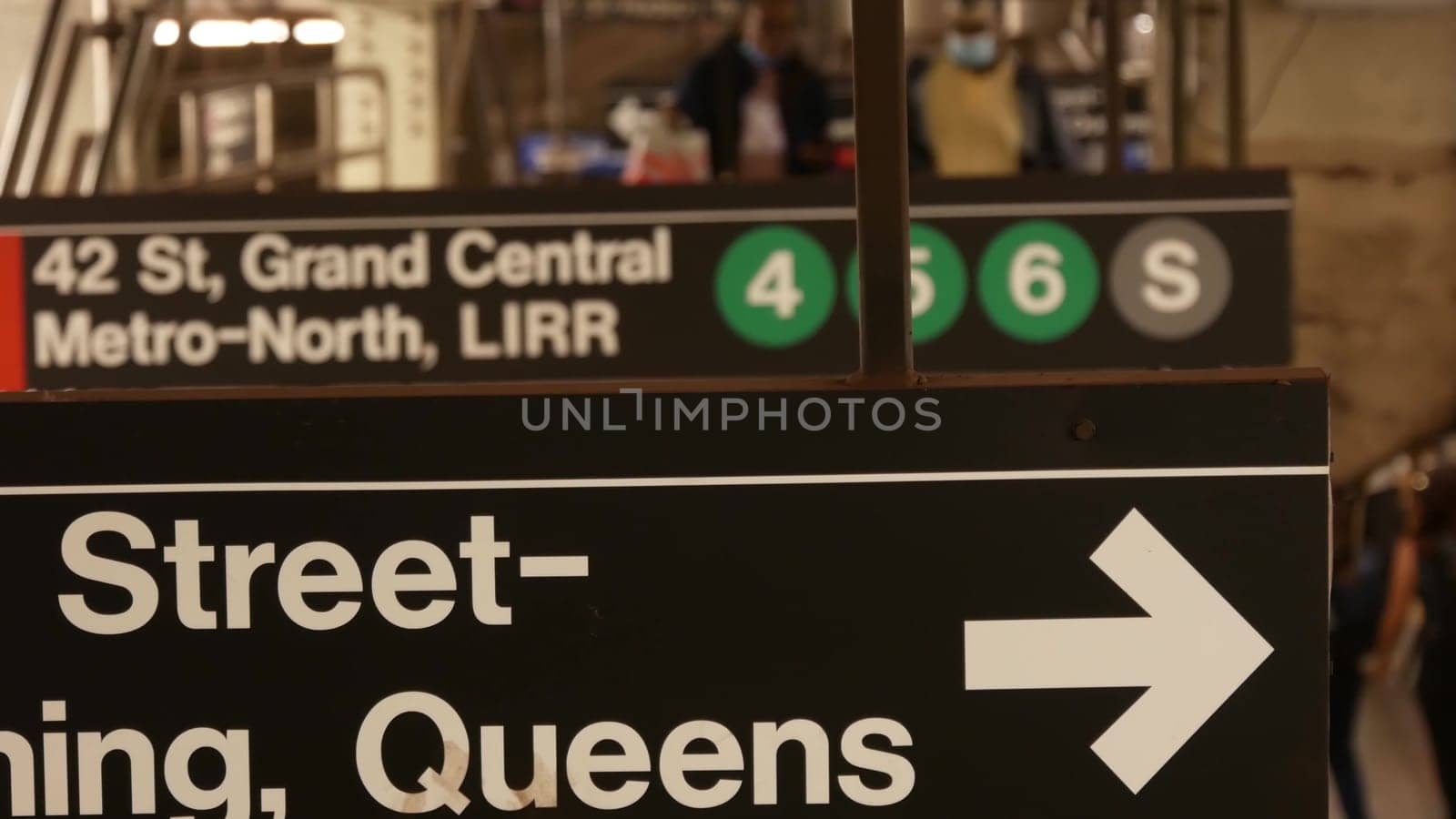 New York City, United States - 29 Aug 2023: Subway station interior, underground metropolitan platform. Public metro transport. Railway passenger traffic. Text sign: Grand Central, 42, Queens. People.