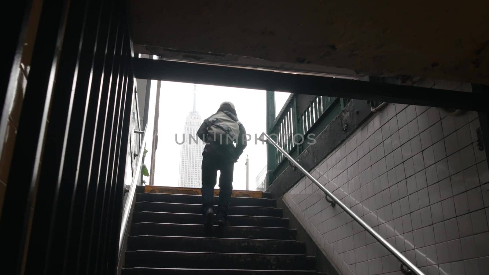 New York City, United States - 30 Aug 2023: Underground subway, metro stairway. Empire State building. Metropolitan entrance. Manhattan Midtown financial business district. African american black man.