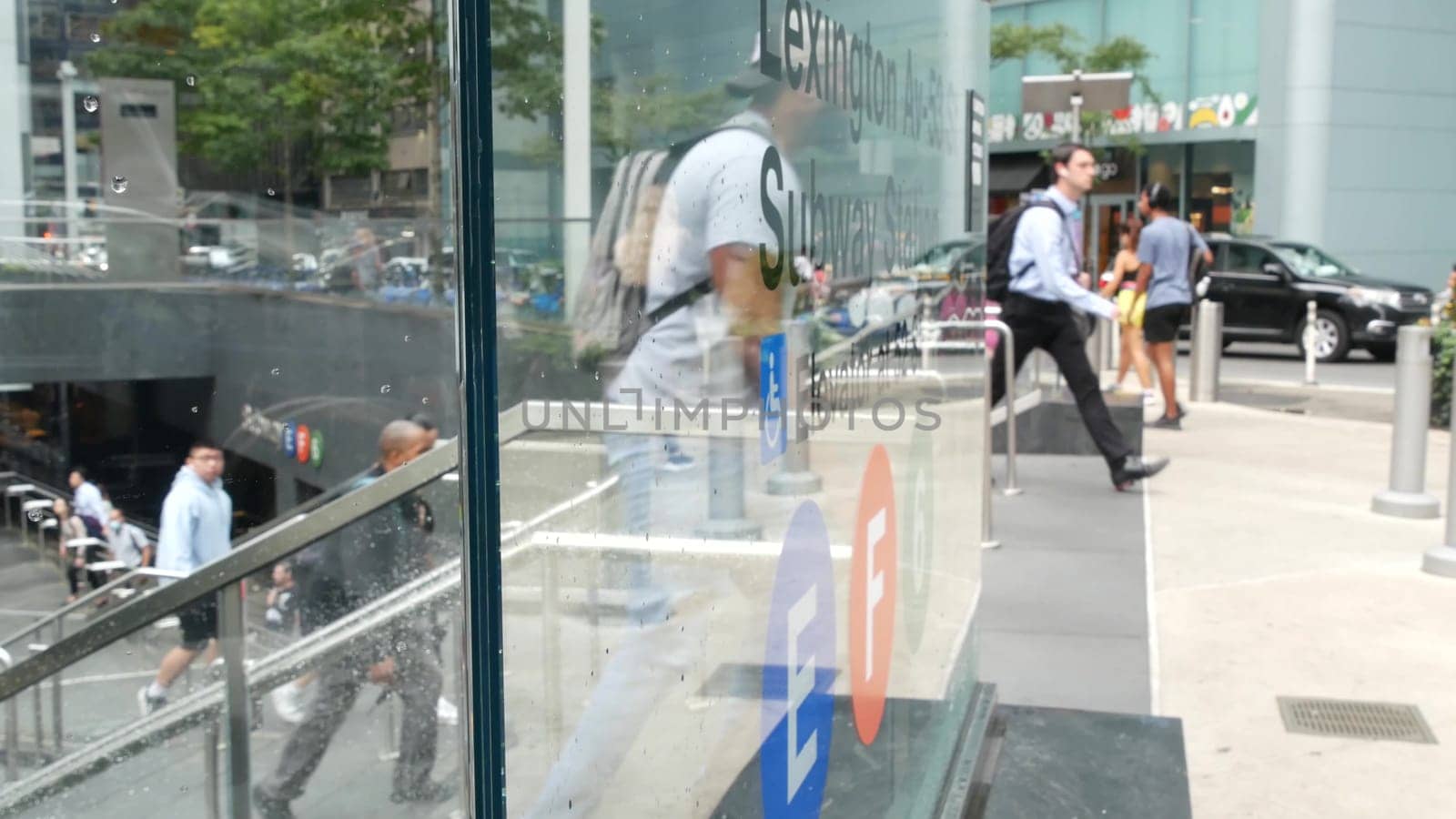 New York City, United States - 11 Sept 2023: Manhattan Midtown Lexington avenue, United States. People pedestrian exit underground subway station, stairs on 53 street, urban USA. Metro entrance sign.