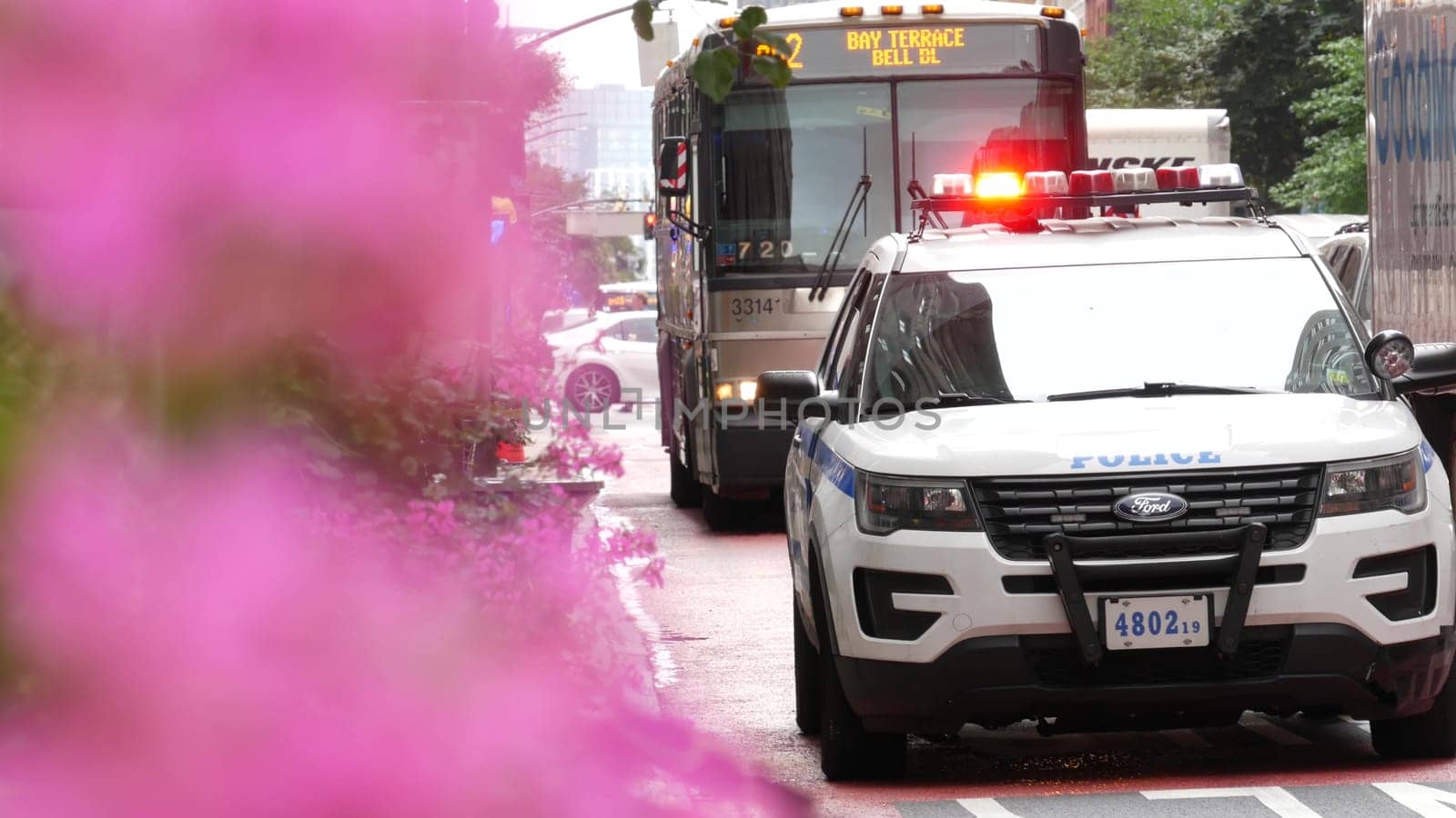 New York City, United States - 29 Aug 2023: Police patrol car, USA NYPD, 911 vehicle on Manhattan Midtown 34th street. American cop auto siren light on avenue. Urban traffic, road transport scene. Bus