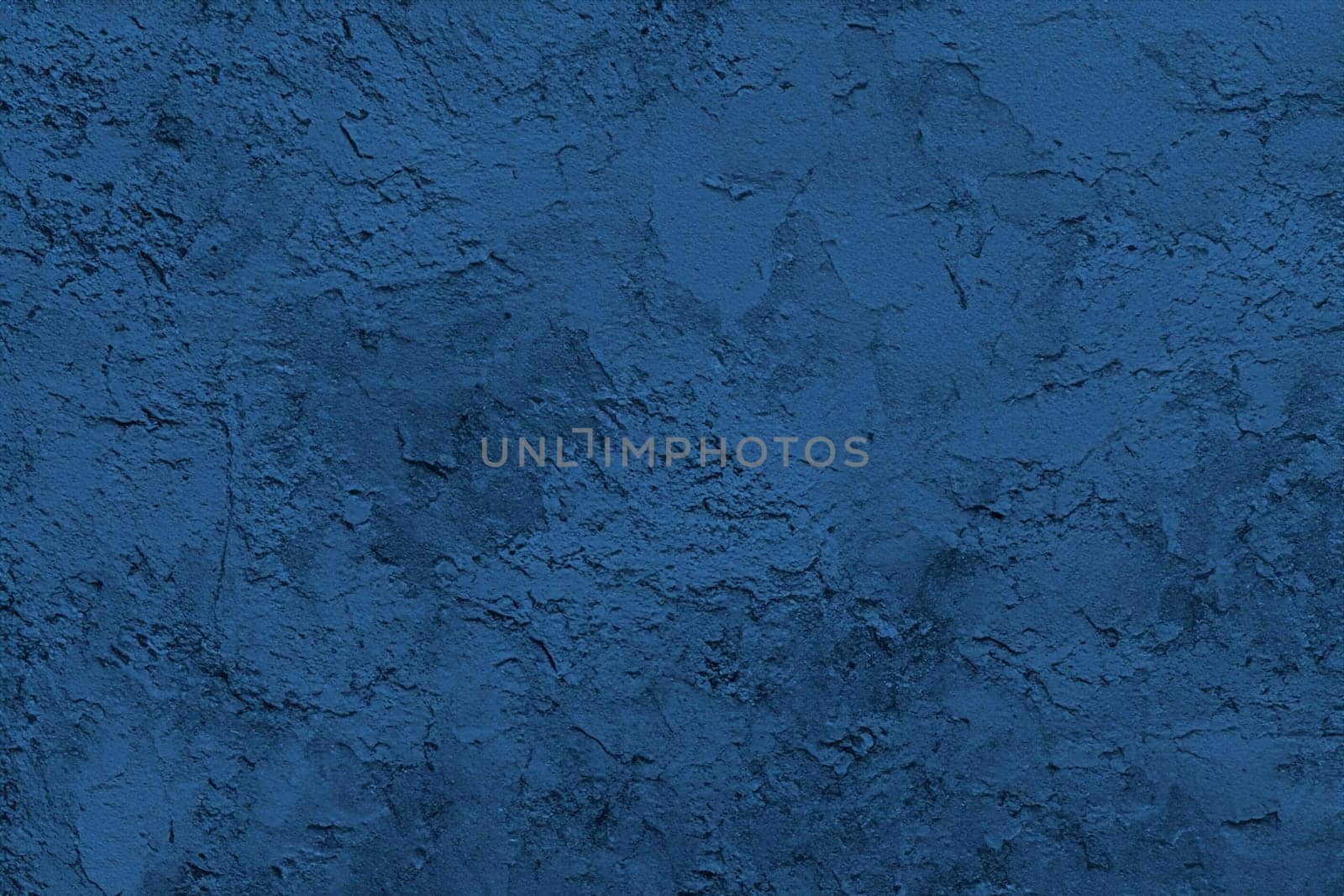 Abstract decorative dark blue plaster wall background