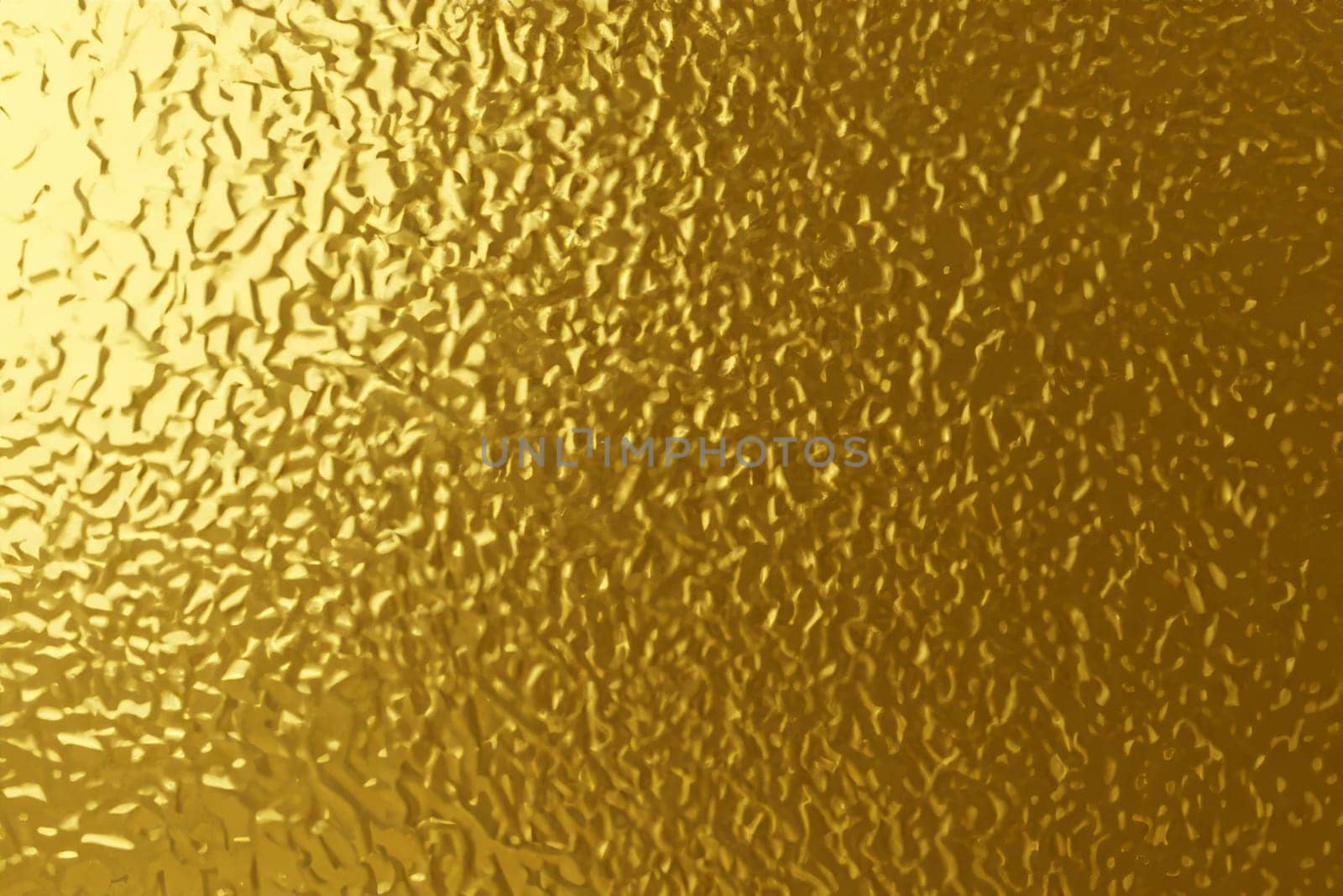 gold foil background with light reflections. golden textured abstract background