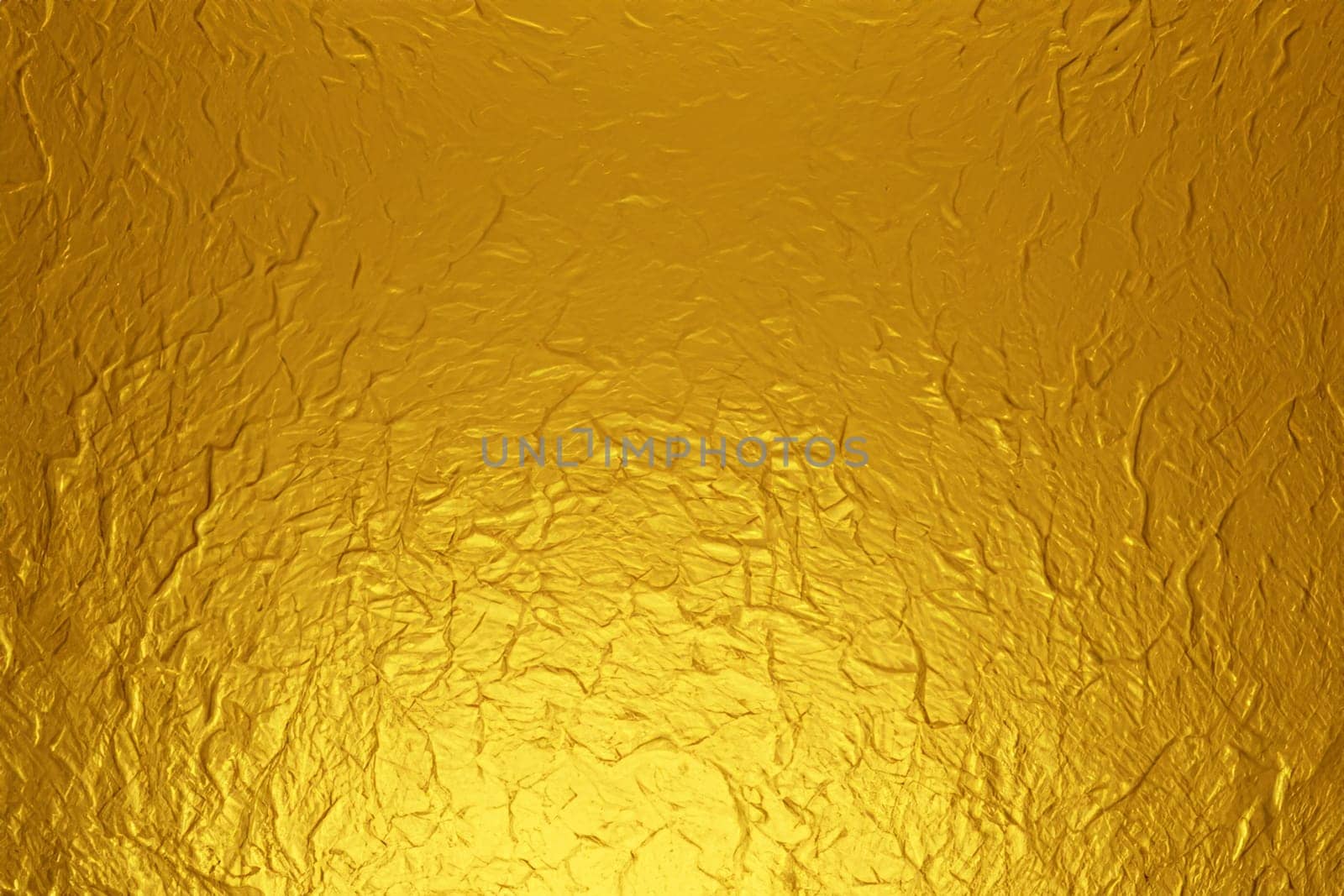 gold foil background with light reflections. golden textured abstract background