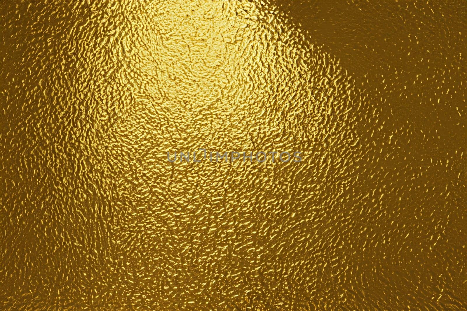 gold foil background with light reflections. golden textured abstract background