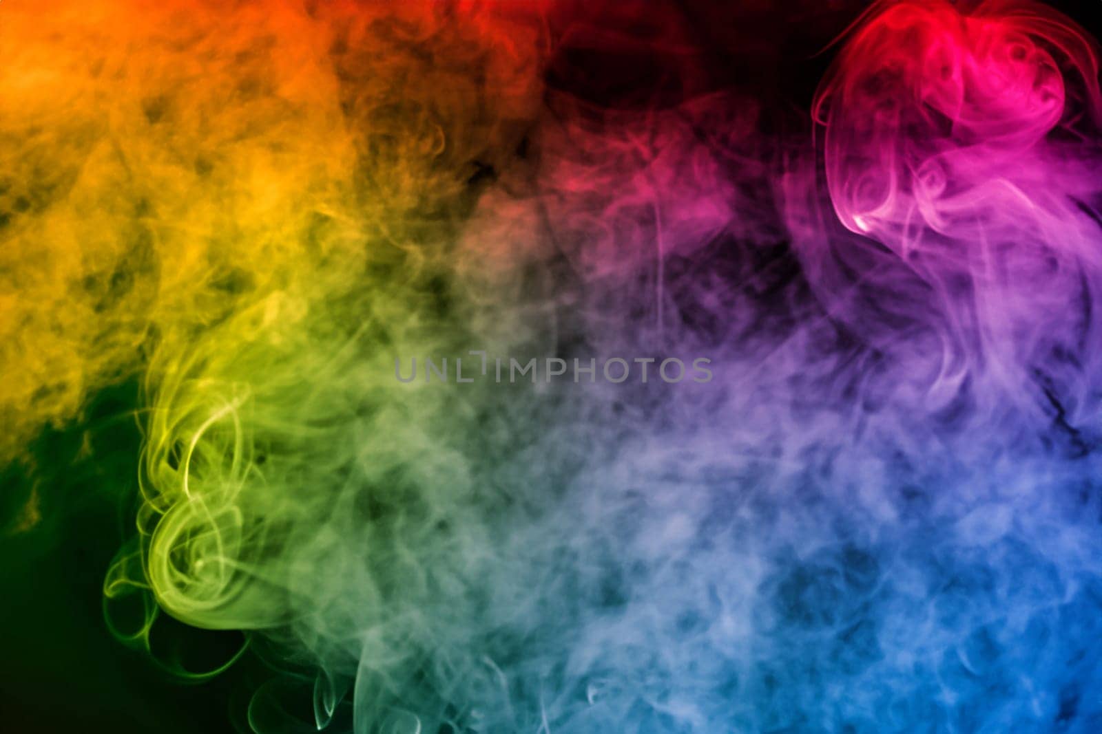 colorful smoke on dark background. artistic colorful background