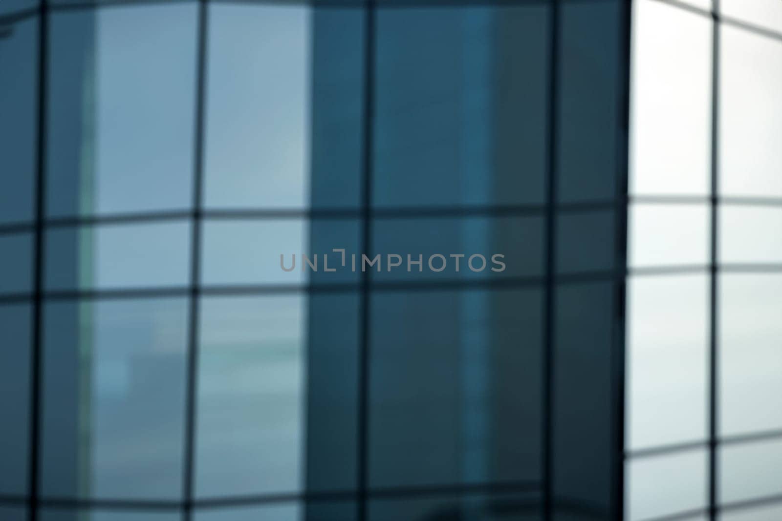 blurred abstract grey glass wall from building background. abstract architectural theme