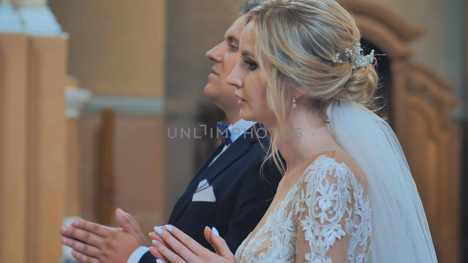 Newlyweds pray in the catholic church