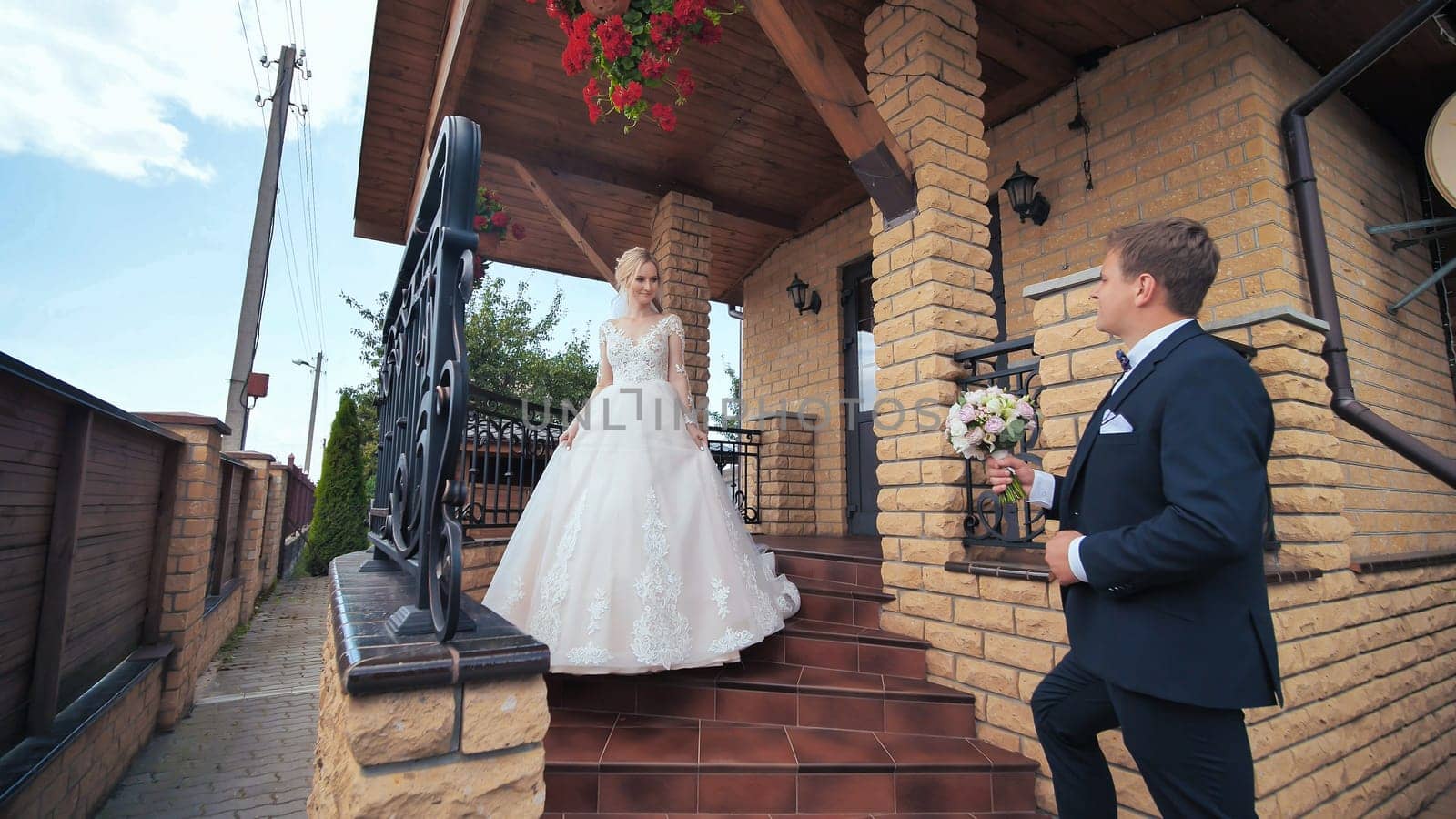 The groom meets his bride and gives her a bouquet