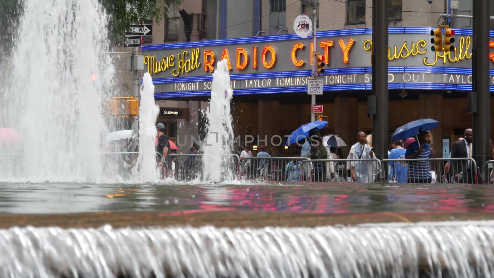 New York, United States - 10 Sept 2023: Manhattan Midtown street. Radio City Music Hall, Rockefeller Center, USA landmark. People pedestrian and urban traffic on 6 Sixth Americas avenue crossroad, NYC