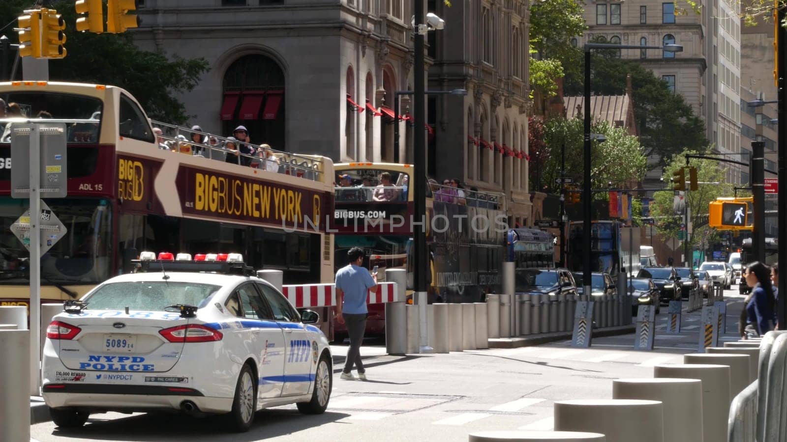 New York City, United States - 31 Aug 2023: Police patrol car, USA NYPD 911 vehicle, Manhattan Downtown Church street, Oculus. American cop auto. Urban road traffic, people crossing on zebra. Big Bus.