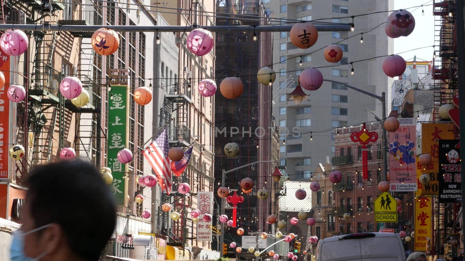 New York City, United States - 14 Sept 2023: Manhattan Chinatown Mott street, chinese ethnic district buildings architecture, USA. Red round paper lanterns, people and hieroglyph signs. Little China.