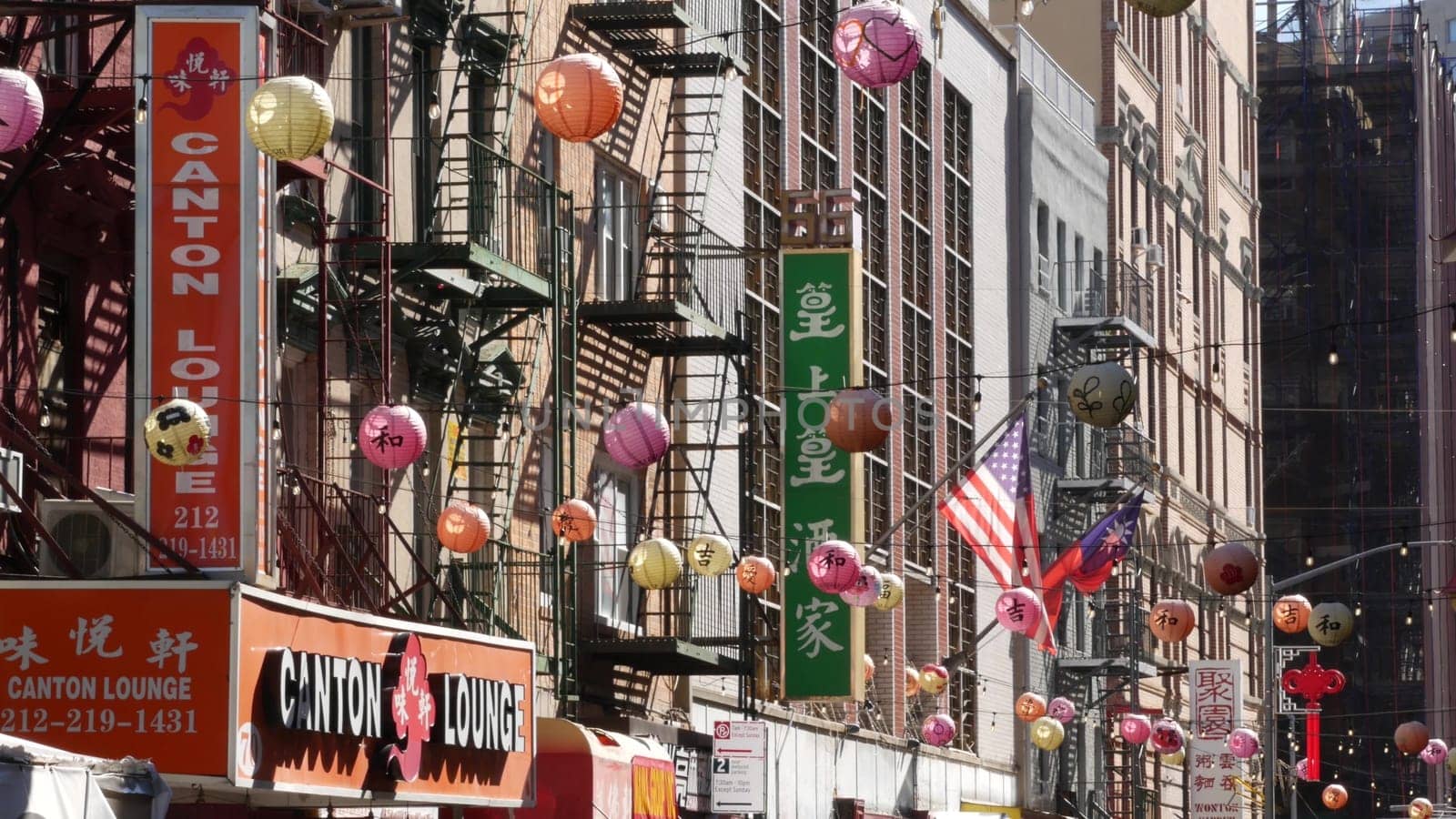 New York City, United States - 14 Sept 2023: Manhattan Chinatown Mott street, chinese ethnic district buildings architecture, USA. Red round paper lanterns, people and hieroglyph signs. Little China.
